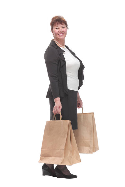 Side view portrait of happy senior woman posing with her shopping bag