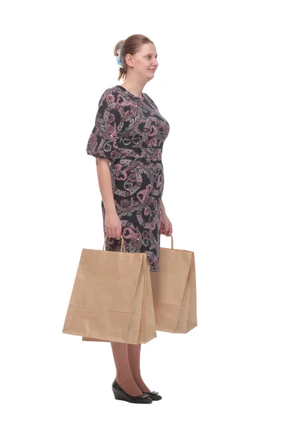 Side view of woman holding shopping bags against white backgroun — Stock Photo, Image