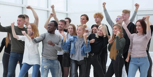 Large group of happy young people showing their success — Stock Photo, Image