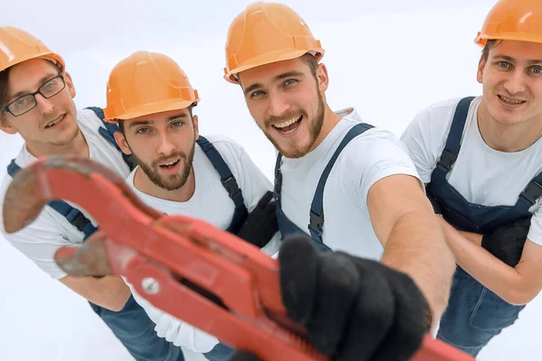 View from the top.group of builders showing a gas key. — Stock Photo, Image
