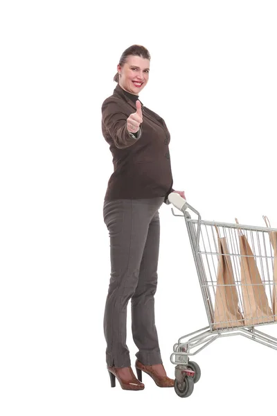 Boční pohled mladé ženy s nákupním vozíkem — Stock fotografie