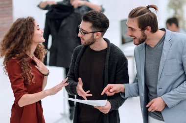 Tasarımcı grubu çizimleri tartışıyor.