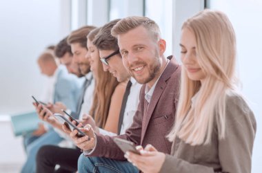 Ofis koridorunda oturan genç iş adamları...