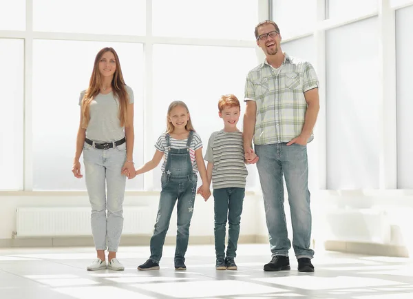 Modern family standing in a new apartment — Stock Photo, Image