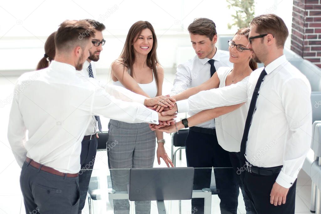 business colleagues folded their hands together .photo with copy space