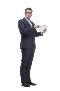 Side view portrait of curious and smiling businessman with tablet looking and pointing to side while standing on white background