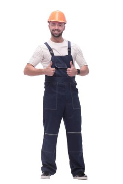 in full growth. smiling man in overalls showing thumbs up . isolated on white background clipart