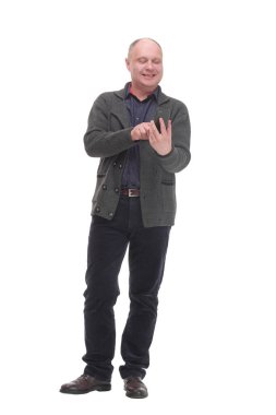 in full growth. smiling mature man with a smartphone .isolated on a white background.