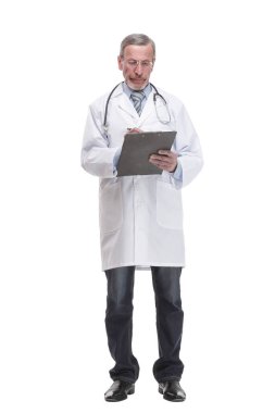 Front view of mature thoughtful doctor writing on clipboard. isolated on white background