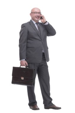 in full growth. business man with a smartphone.isolated on a white background.