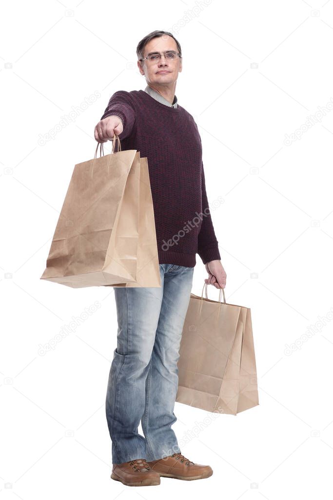full-length. casual man with shopping bags. isolated on a white background.