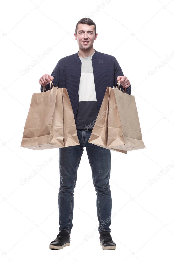 smiling young man with shopping bags . isolated on a white background.