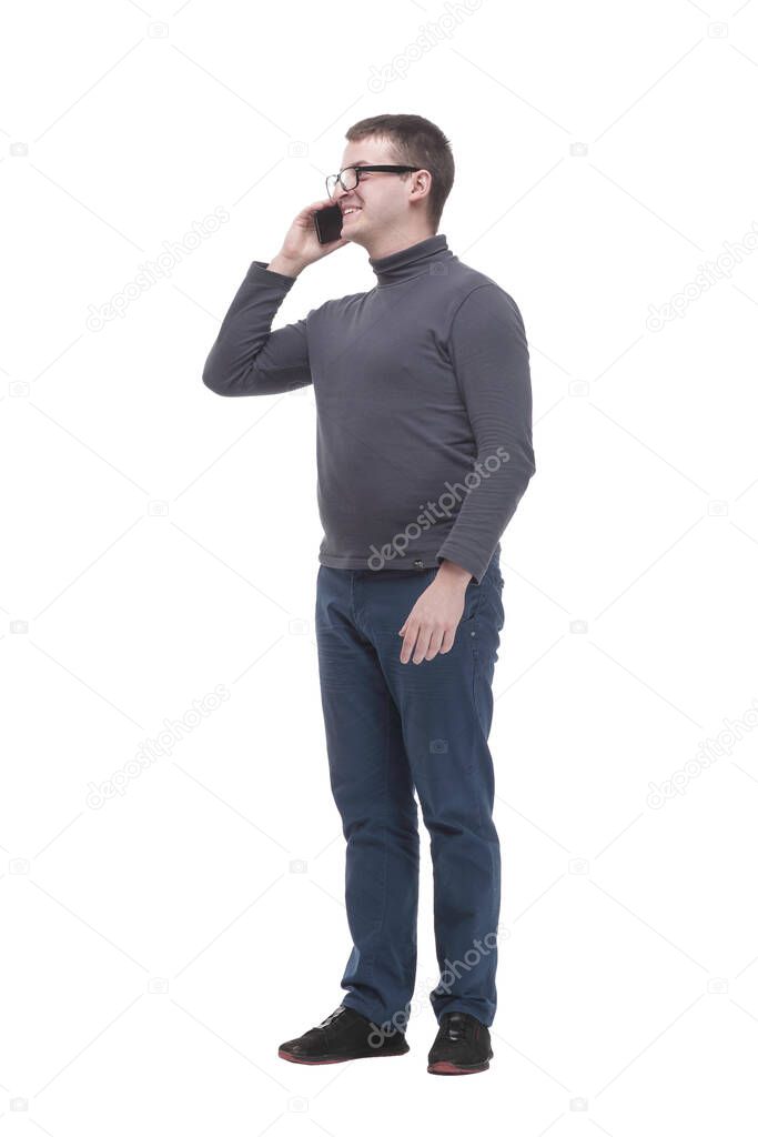 in full growth. casual young man with a smartphone. isolated on a white background.