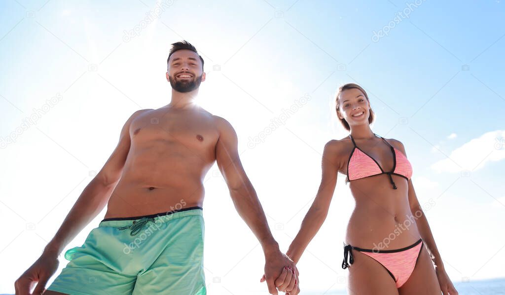 Below view of couple having fun while running through sea.