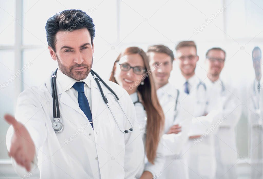 doctor is holding out his hand for a greeting . photo with copy space