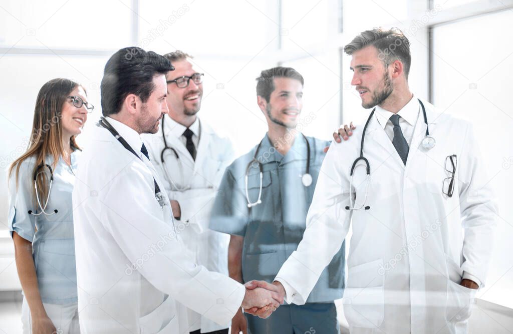 doctors shaking hands in hospital corridor.the concept of cooperation