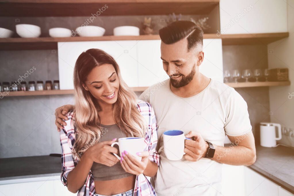 close up. young couple in love in the kitchen in a good morning