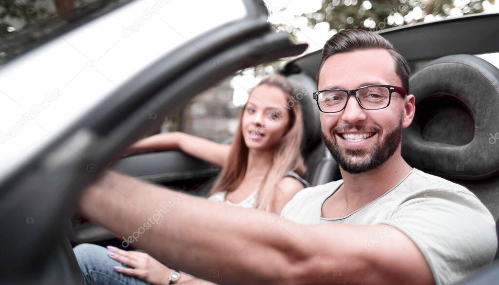 close up.young man driving a convertible car