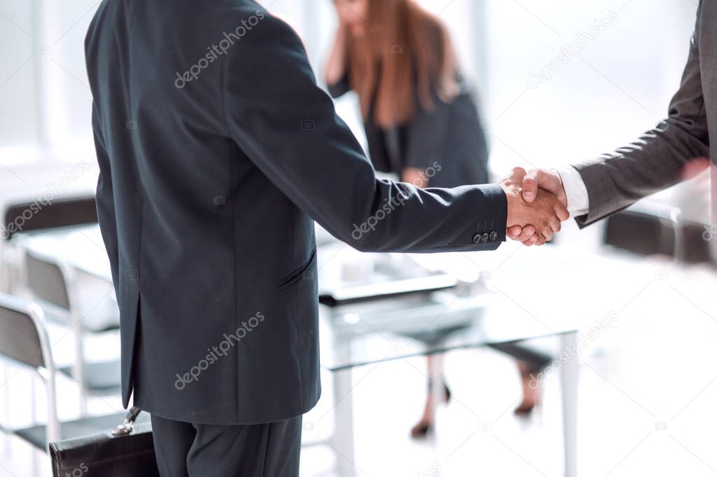 handshake of business people in the background of the office. concept of cooperation
