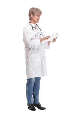 Full lenth portrait of a happy senior doctor working with a tablet, on white background