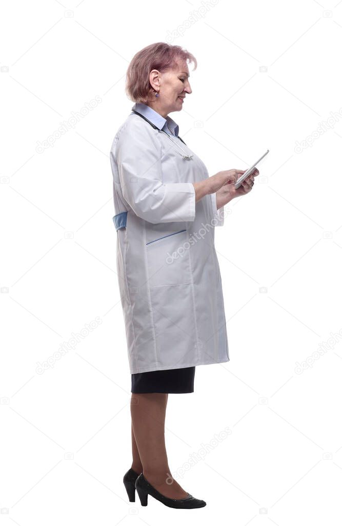 side view. female doctor using a digital tablet. isolated on a white background