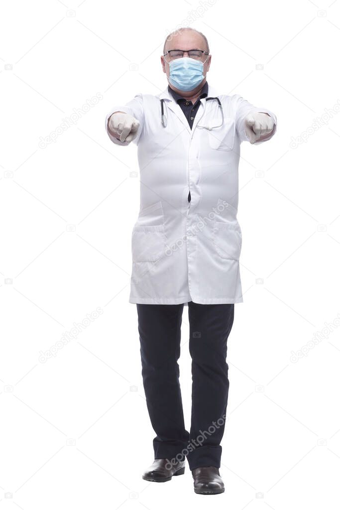 in full growth. a serious doctor in a protective mask . isolated on a white background