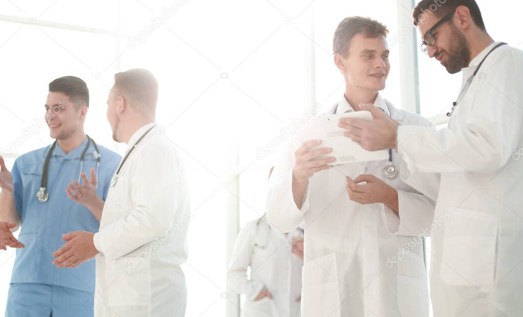 medical professionals looking at the screen of a digital tablet. people and technology