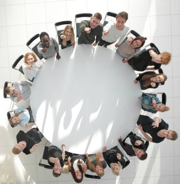 top view. a group of young people applaud at a group meeting . photo with copy space