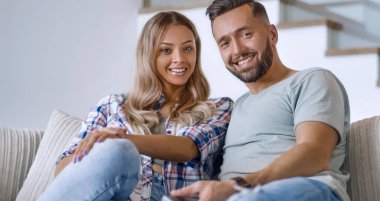 Kapat. Sıcak oturma odasındaki kanepede oturan sevgili çift.