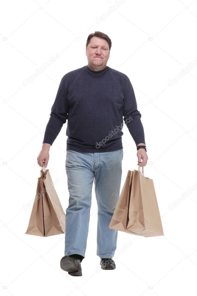 in full growth. casual mature man with shopping bags .isolated on a white background.