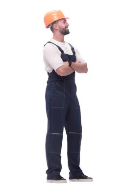 in full growth. smiling man in overalls and a safety helmet . isolated on white background clipart