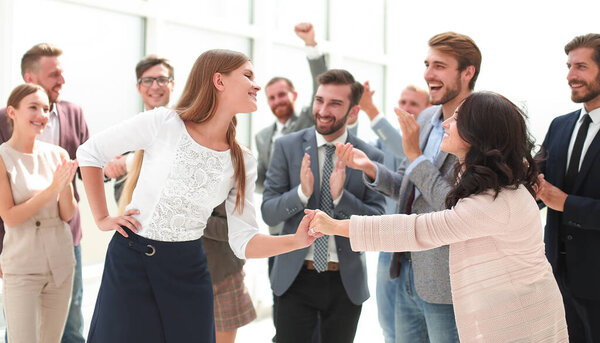 young employees congratulating each other on the victory. success concept