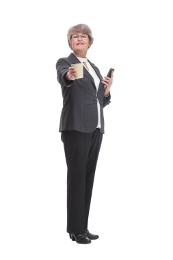 Portrait of a mature attractive stylish woman retired with a cup of coffee and a smartphone in her hand and looking at camera