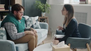 İlgili terapistin su vermesi ve modern ofisteki hastalarla konuşması.