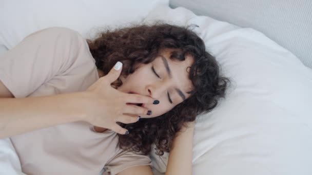 Retrato de menina relaxada bocejando e dormindo deitado na cama em casa desfrutando de descanso — Vídeo de Stock