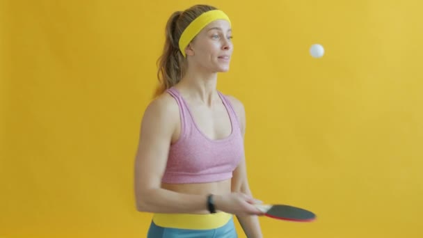 Portrait of happy girl playing table tennis having fun with ball and rocket smile — Stok Video