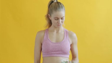 Sebze salatasını işaret eden ve gülümseyen zayıf sporcu kadının yavaş hareketi.