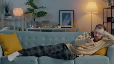 TV seyreden yorgun bir gencin portresi. Sonra akşam evde kanepede uyuyor.