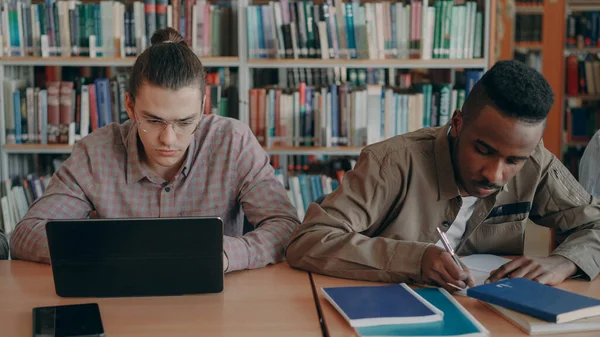 Két Koncentrált Diák Vizsgára Készül Miközben Egyetemi Könyvtárban Ülnek Asztalnál — Stock Fotó
