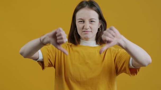 Slow Motion Portrait Displeased Young Woman Gesturing Thumbs Wrinkling Nose — Stock Video