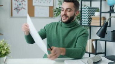 Uzak sınıfta kimya dersi veren genç bir adam görsel yardım gösteriyor ve kameraya bakıyor. Uzaktan eğitim ve bilim konsepti.