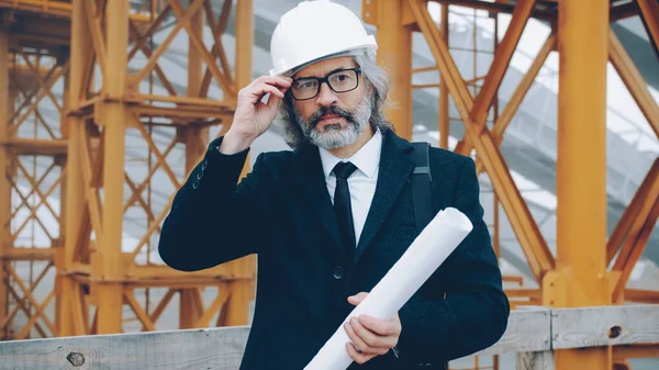 Retrato Engenheiro Sênior Área Construção Segurando Planta Tocando Óculos Livre — Fotografia de Stock