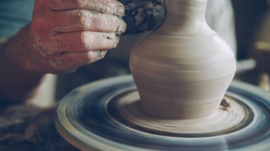Yaşlı sakallı usta seramik kavanoz profesyonel araçlar kullanarak potters tekerlek üzerinde yaratıyor. Çalışma alanı ile el yapımı tencere, güzel vazolar ve arka plan resimler.