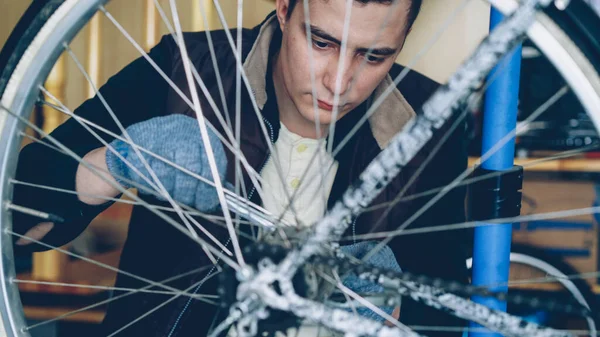 Concentrated Handsome Guy Skilled Mechanic Repairing Bicycle Wheel Wrenchwhile Working — Stock Photo, Image