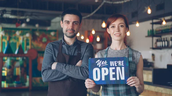 Glückliche Attraktive Menschen Schürzen Halten Ein Schild Hoch Und Lächeln — Stockfoto