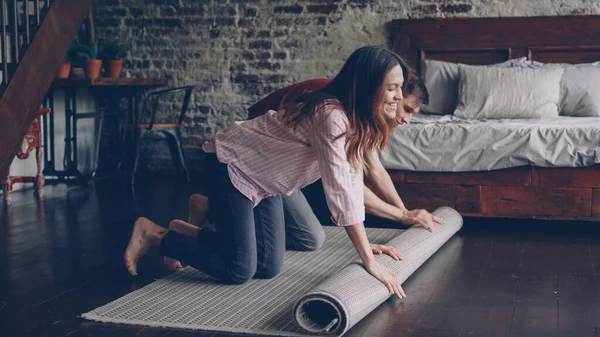 Happy Husband Wife Unrolling Carpet New House Enjoying Beautiful Bedroom — Stock Photo, Image