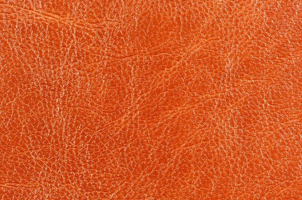 Mörkt orange glansigt läder bakgrundsstruktur — Stockfoto
