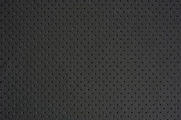 Tmavě šedé perforované koženky pozadí textury — Stock fotografie