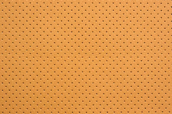 Amarelo perfurado textura de fundo de couro artificial — Fotografia de Stock