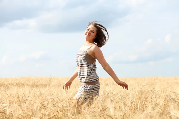Happy woman in golden wheat Stock Image